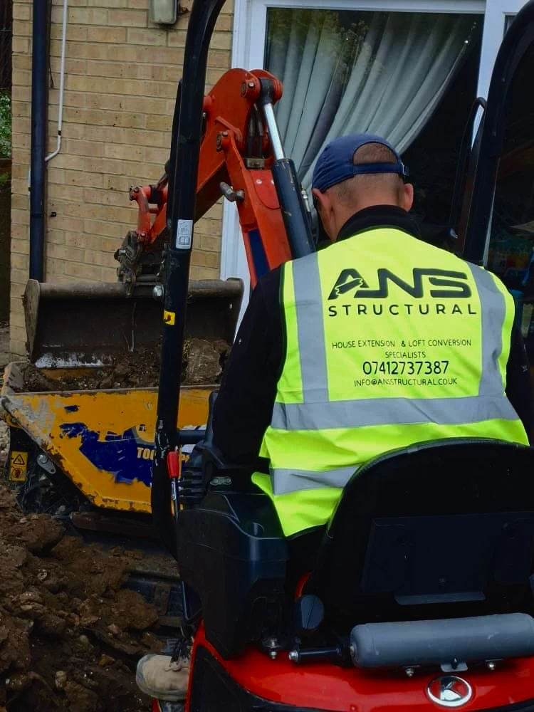 ANS Structural operator digging footings for a house extension