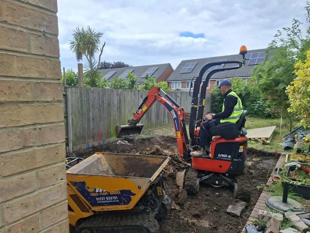 Micro-digger and tracked dumper excavating a tight rear garden for an extension