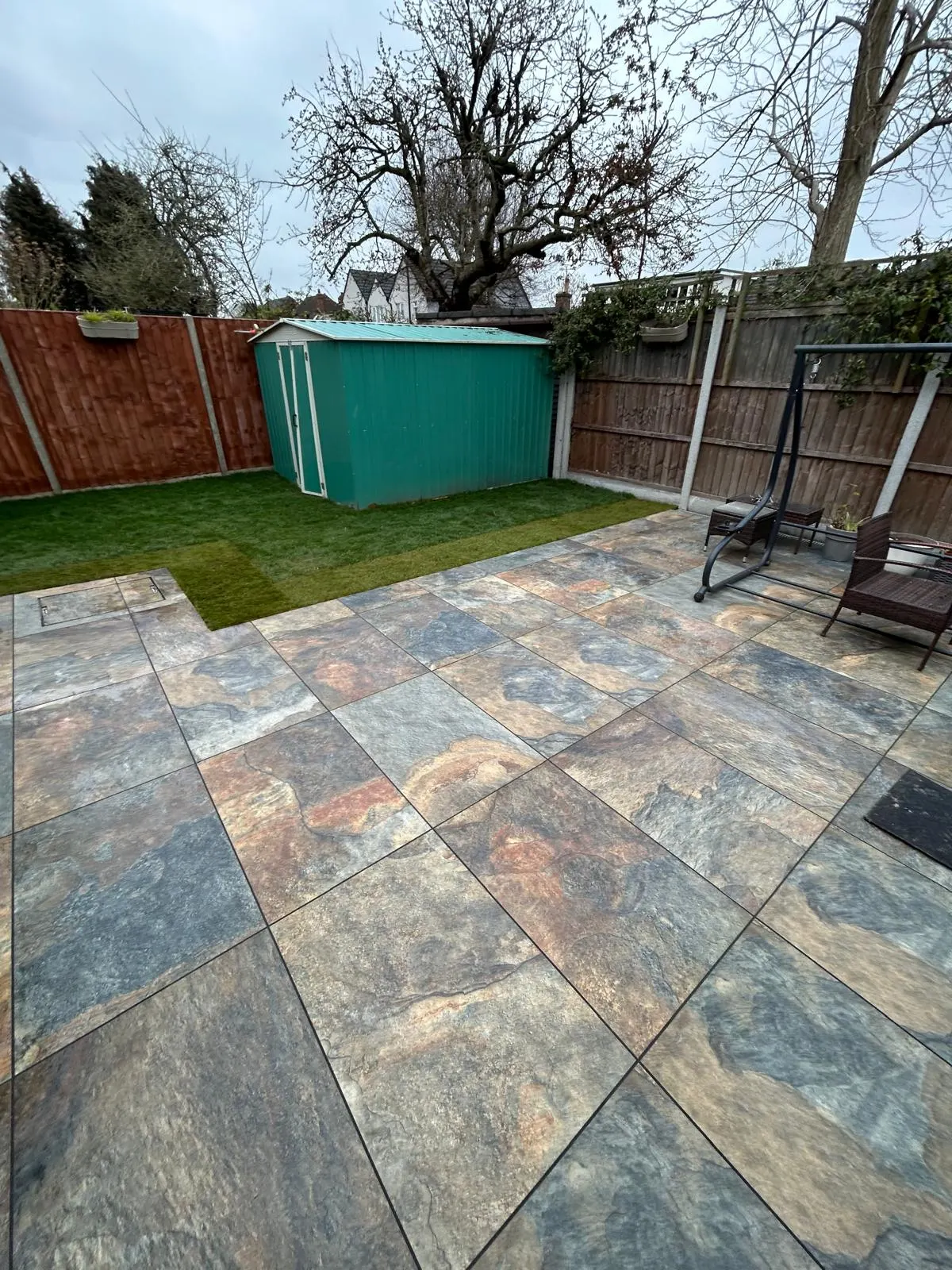 Finished porcelain patio and fresh turf at handover of a completed garden project
