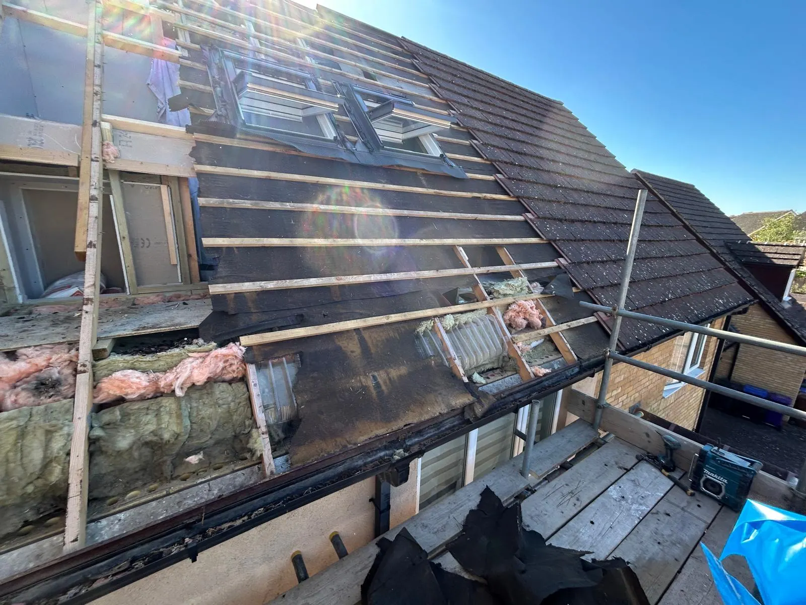 Roof stripped back to the battens with old insulation exposed ready for a dormer build