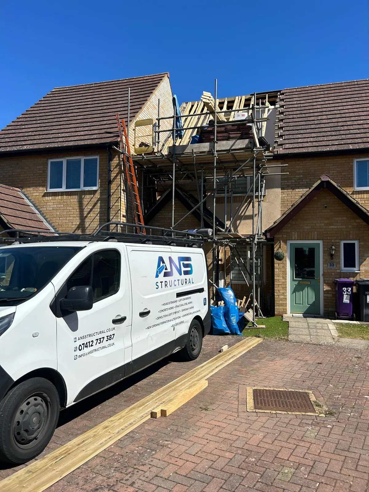 ANS Structural van parked below scaffolding with new roof timbers going in above
